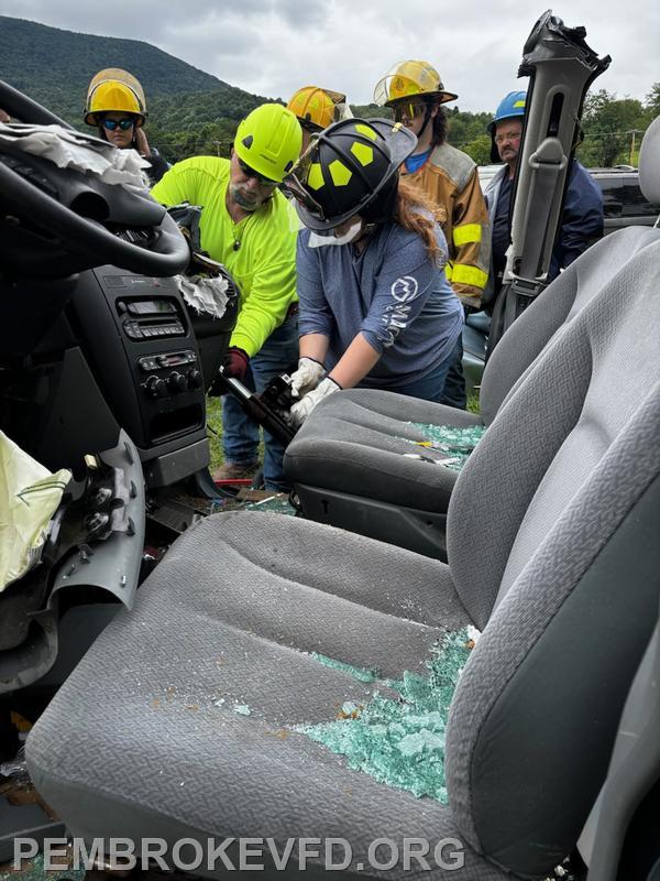 Firefighter Emma Mills using a ram to make room for patient removal