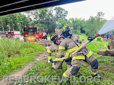Apprentice members learning how to handle the hose with different nozzle pressures